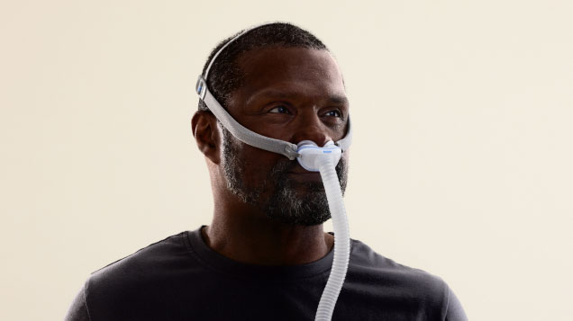 Man wearing the ResMed AirFit P10 nasal pillows CPAP mask
